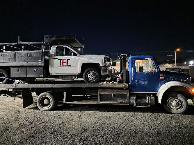 Work truck loaded on the Snoway flatbed at night